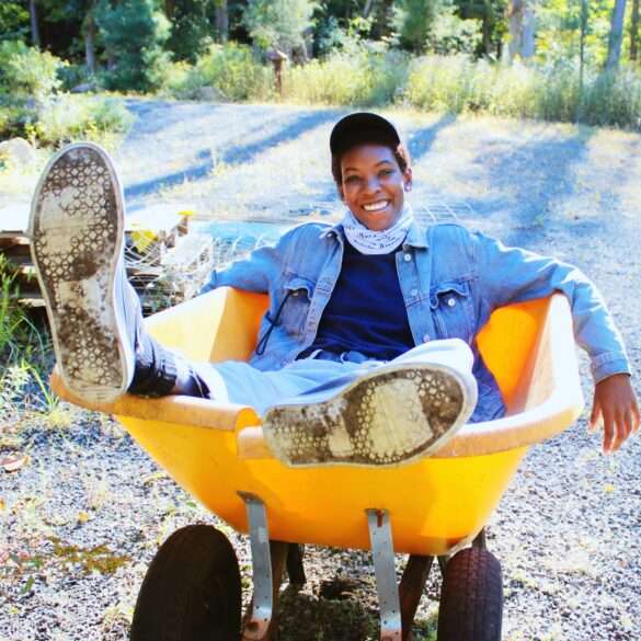 jovial gardener playfully resting in wheelbarrow