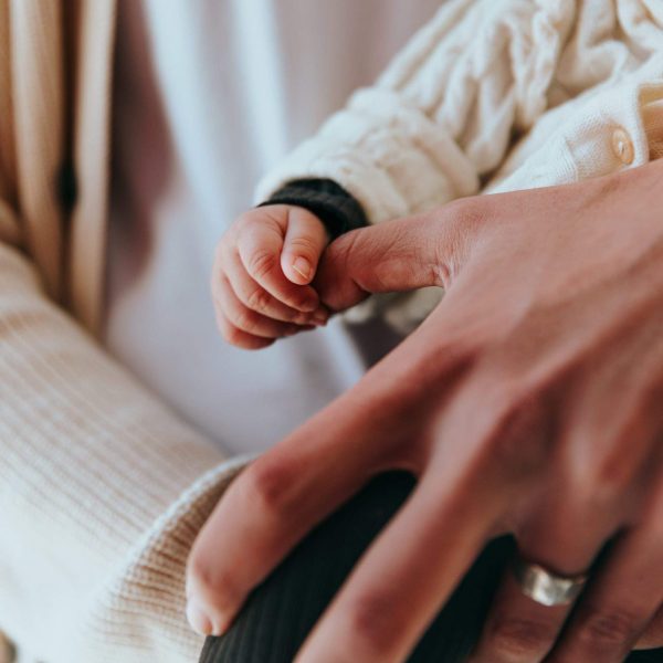 baby holding parent's hand